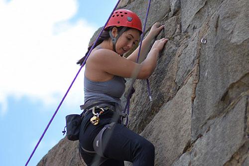 student rock climbing