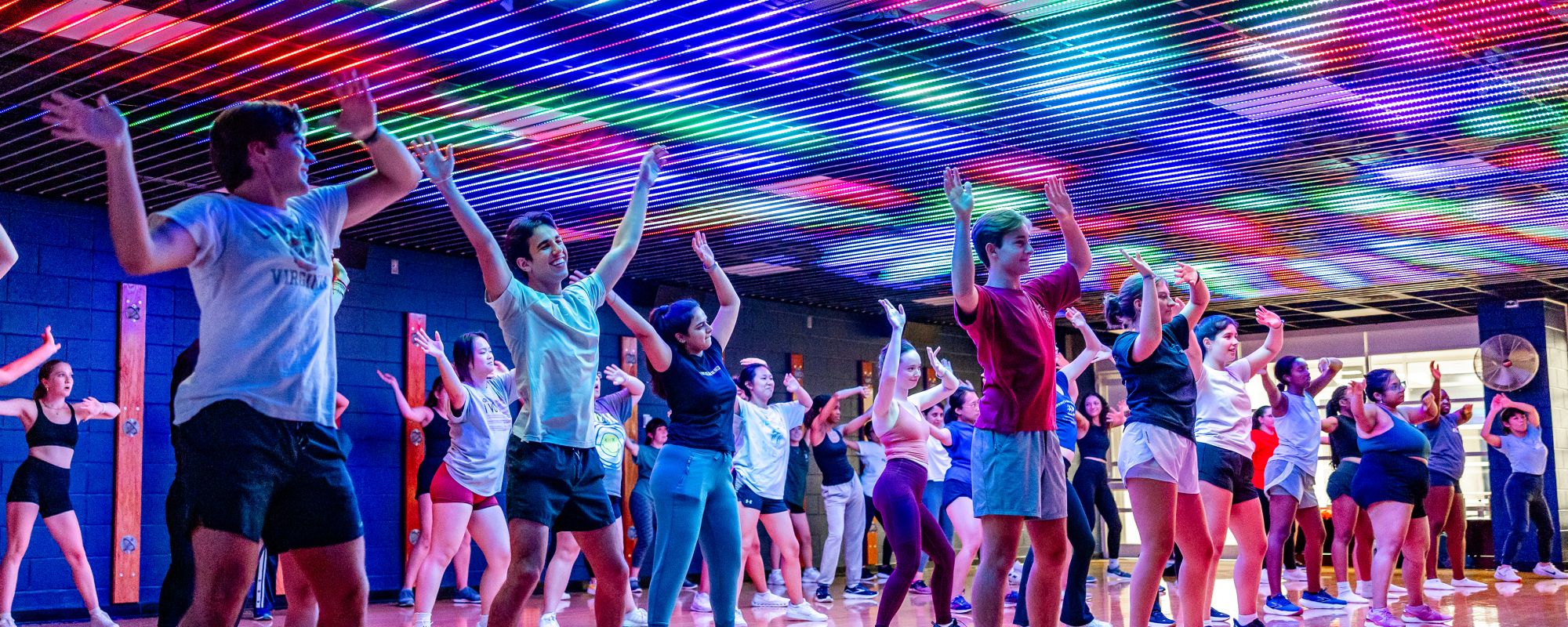 Students doing Zumba in a colorful MP Room