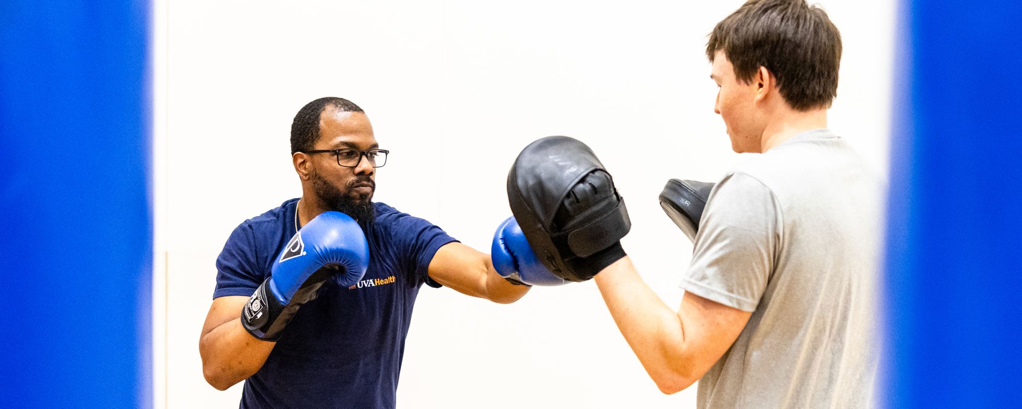 Two people in a boxing class